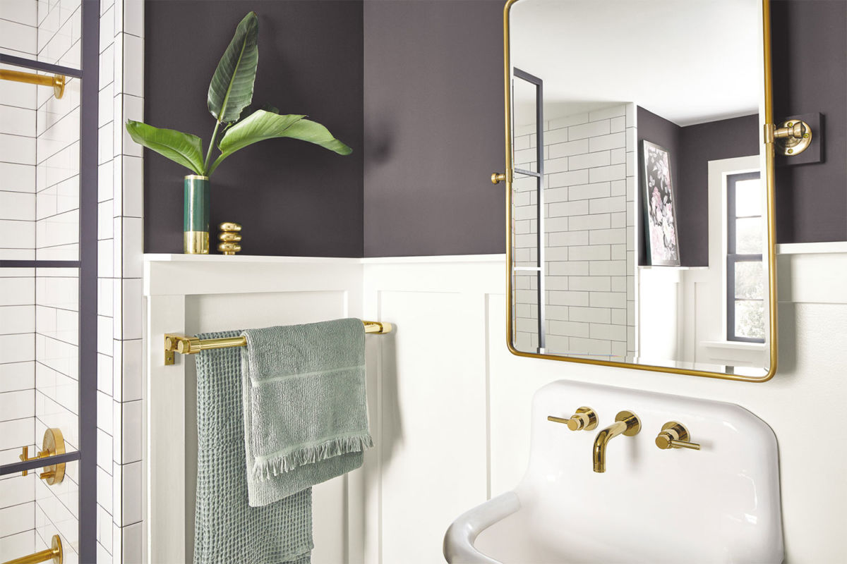 Closeup of bathroom sink with gold fixtures painted in Perle Noir SW 9154