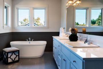 bathroom, white and dark gray walls, big mirror above two lavatories