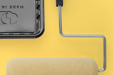 painting roller and frame on yellow background