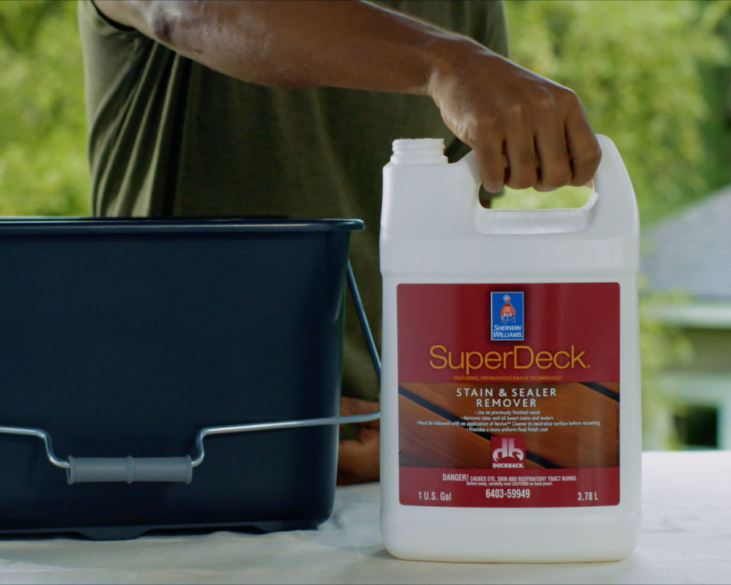 man holding super deck stain remover