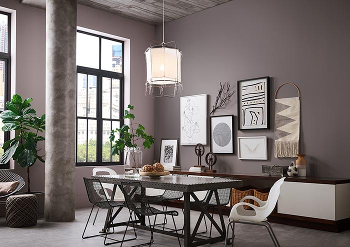 Open-floor concept industrial dining room with walls painted in tints and shades of purple Queen Anne Lilac SW 0021 and Slate Violet SW 9155.