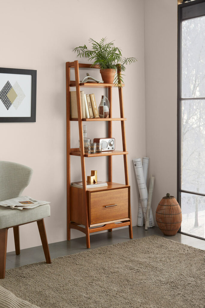 vignette of a wooden bookshelf in an apartment with floor-to-ceiling windows