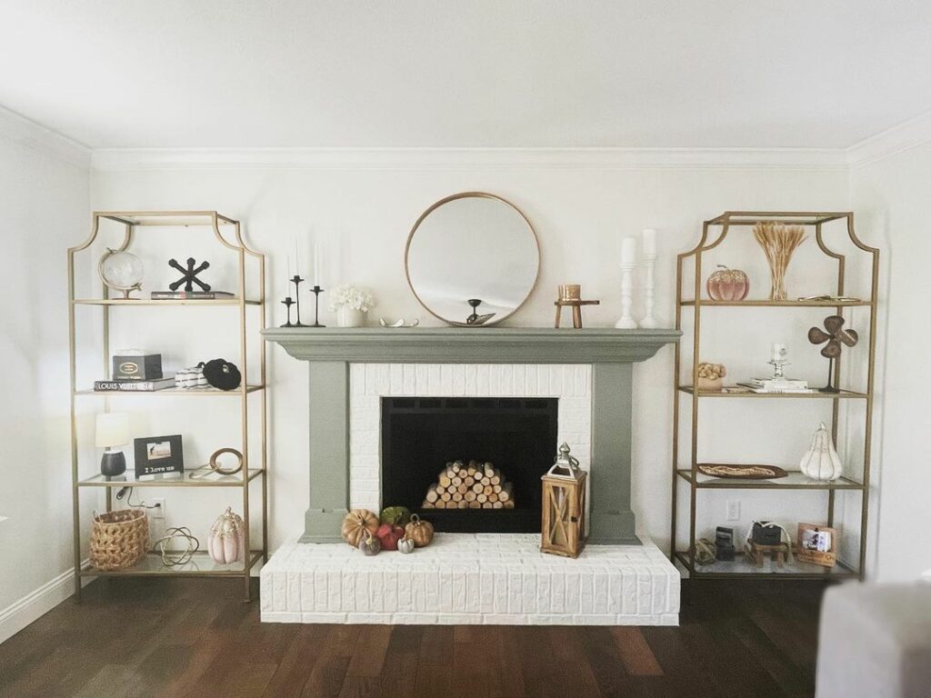Living room with a brick fireplace and walls painted in Alabaster and a mantel painted in Evergreen Fog from Sherwin-Williams.