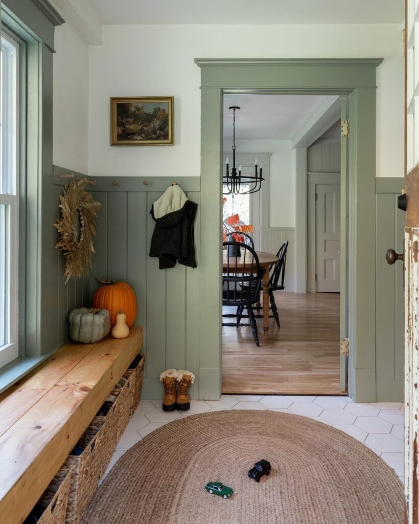 Farmhouse mudroom with door trim, window trim and wainscotting painted in Evergreen Fog from Sherwin-Williams.