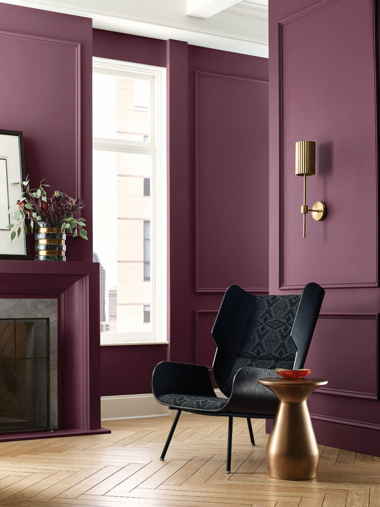 berry colored living room with black and gold accents