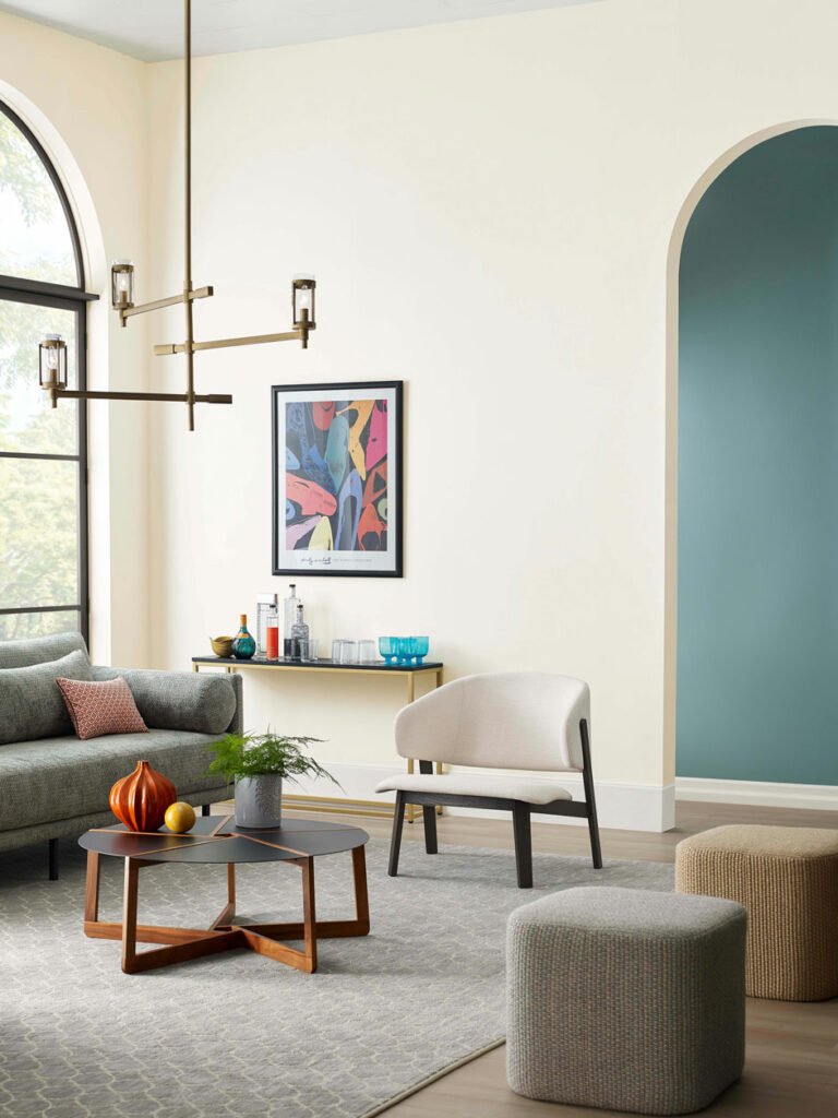 high-ceiling living room with arched entryway.