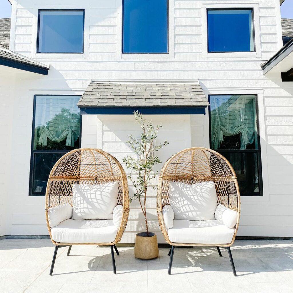 modern patio featuring walls painted in Shoji White and two bohemian chairs.