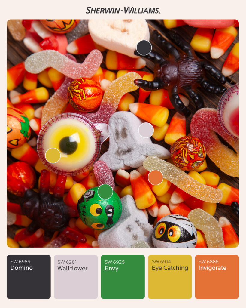 Photo of Halloween candy including gummy worms, gummy spiders, candy corn, marshmallow ghosts, and candy eyeballs. Round color dots over the photo correlate to Sherwin-Williams paint swatches below the image. Colors include Domino SW 6989, Wallflower SW 6281, Envy SW 6925, Eye Catching SW 6914, Invigorate SW 6886.