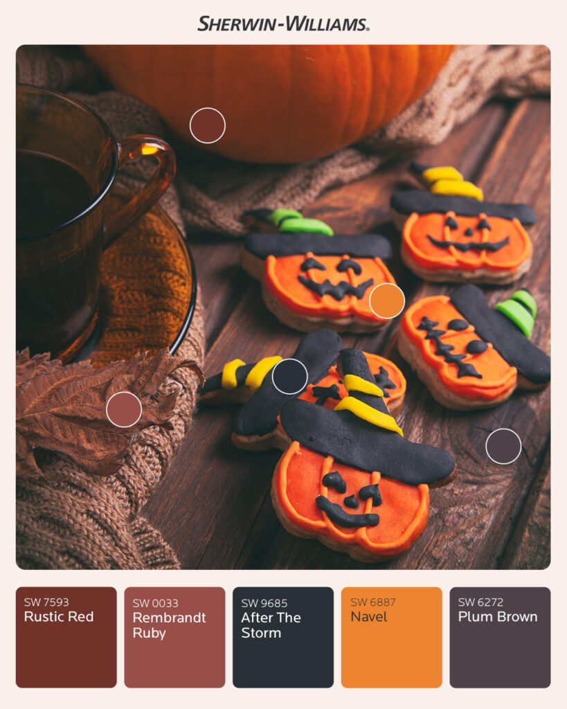 Photo of Halloween cookies laying on a wooden table surrounded by a pumpkin, scarf, leaves, and a teacup. Each pumpkin-shaped cookie has a smiley face made from icing and is wearing a striped witch’s hat. Round color dots over the photo correlate to Sherwin-Williams paint swatches below the image. Colors include Rustic Red SW 7593, Rembrandt Ruby SW 0033, After The Storm SW 9685, Navel SW 6887, and Plum Brown SW 6272.