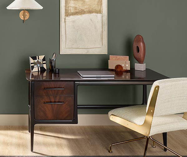 An office desk in front of a wall painted Rosemary SW 6187.