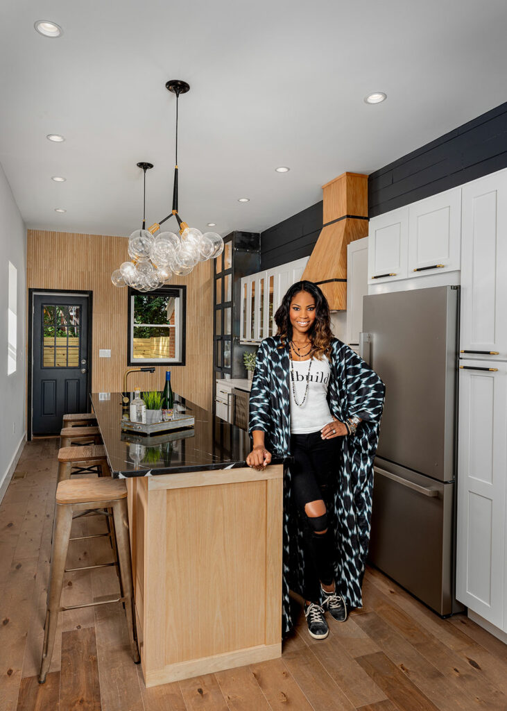 woman standing in a newly renovated kitchen