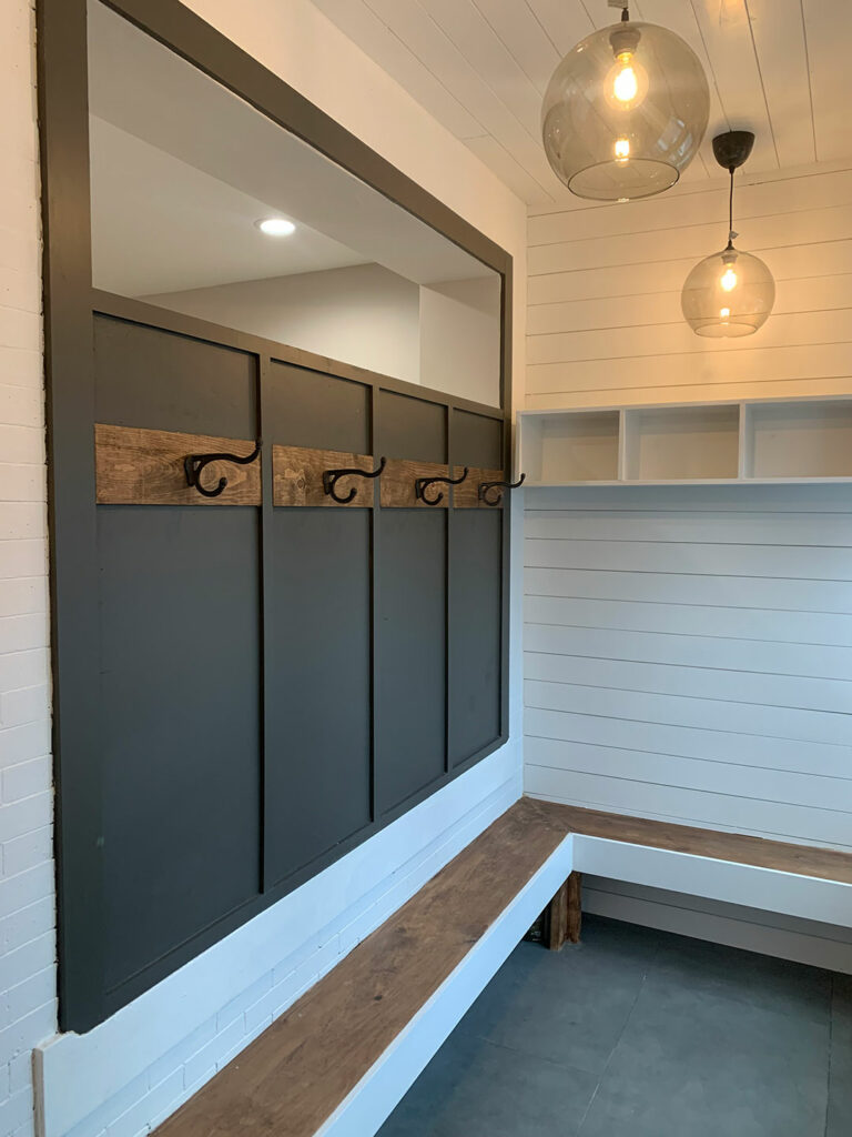 detail shot of a newly renovated mudroom with wainscoting and shiplap walls