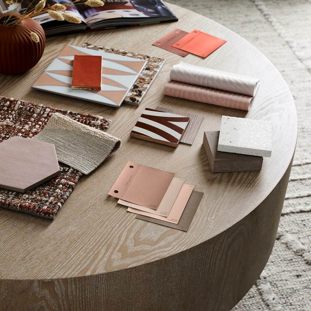 Wooden table with materials and color swatches that represent the nexus palette flatlay.