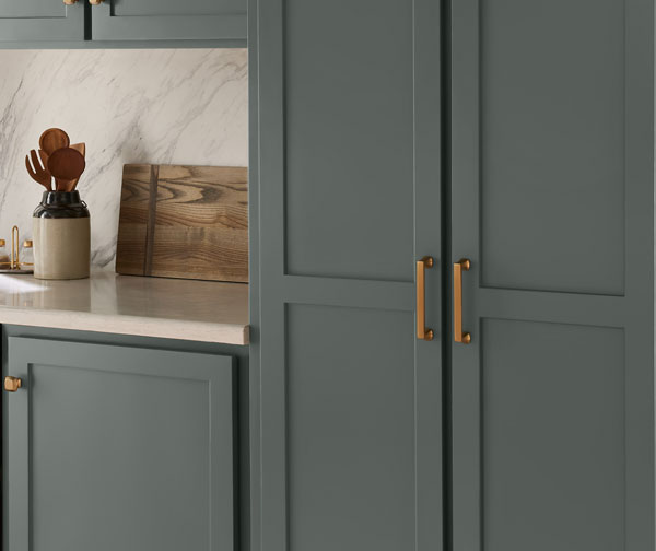 Closeup of kitchen cabinets with gold hardware