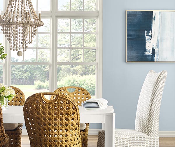Coastal style dining room with walls painted Upward SW 6239.