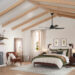 High-ceiling bedroom with exposed beams.